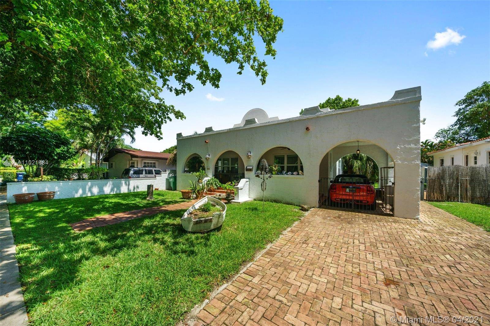 Charming bungalow on a tree lined street, just minutes to world class shopping, dining and entertainment in Coral Gables Coconut Grove.