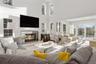 Living area with plenty of natural light, a glass covered fireplace, a high ceiling, and wood finished floors