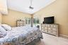 The Primary Suite offers a PEACEFUL RETREAT with its own sliding glass doors opening directly to the patio and pool.