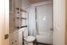 Full bathroom with vanity, toilet, tile walls, and shower / bath combo