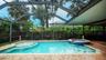 Full sized pool with spa and walk-in pool sunbath area.