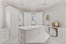 Spacious walk-in closet with custom built-ins offering exceptional storage and organization.