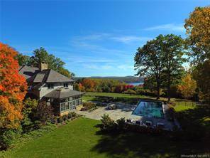 LUXURY LIVING WITH LAKE VIEWS Custom designed hilltop retreat located in Salisbury offers complete privacy.