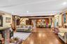 Living room with hardwood / wood-style floors, beam ceiling, and recessed lighting