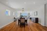Open-concept living area featuring wood-finish flooring, recessed lighting, and expansive windows