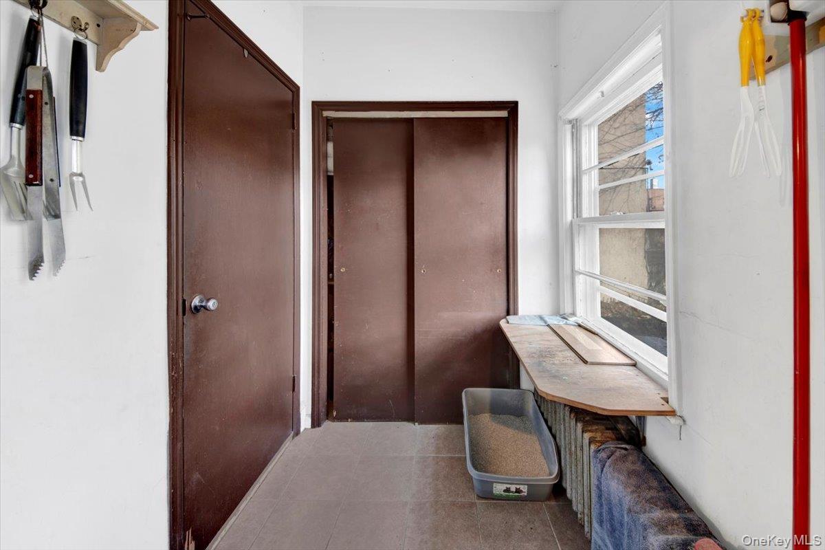 Hall featuring tile patterned flooring