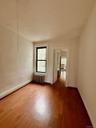 Empty room featuring radiator and wood finished floors
