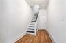 Staircase featuring a baseboard radiator and wood finished floors