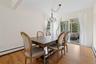 Dining room featuring light wood-style floors, healthy amount of natural light, and a chandelier