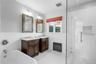 Primary bathroom en suite with 2 sink vanity, soaking tub, walk in shower and separate toilet room.