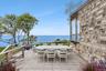 Wooden deck featuring a water view and outdoor dining area