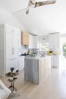 Open Gourmet Kitchen With Glass Sliders Leading To Backyard.