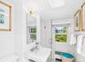 Bathroom featuring wainscoting and a pedestal sink with chrome fixtures