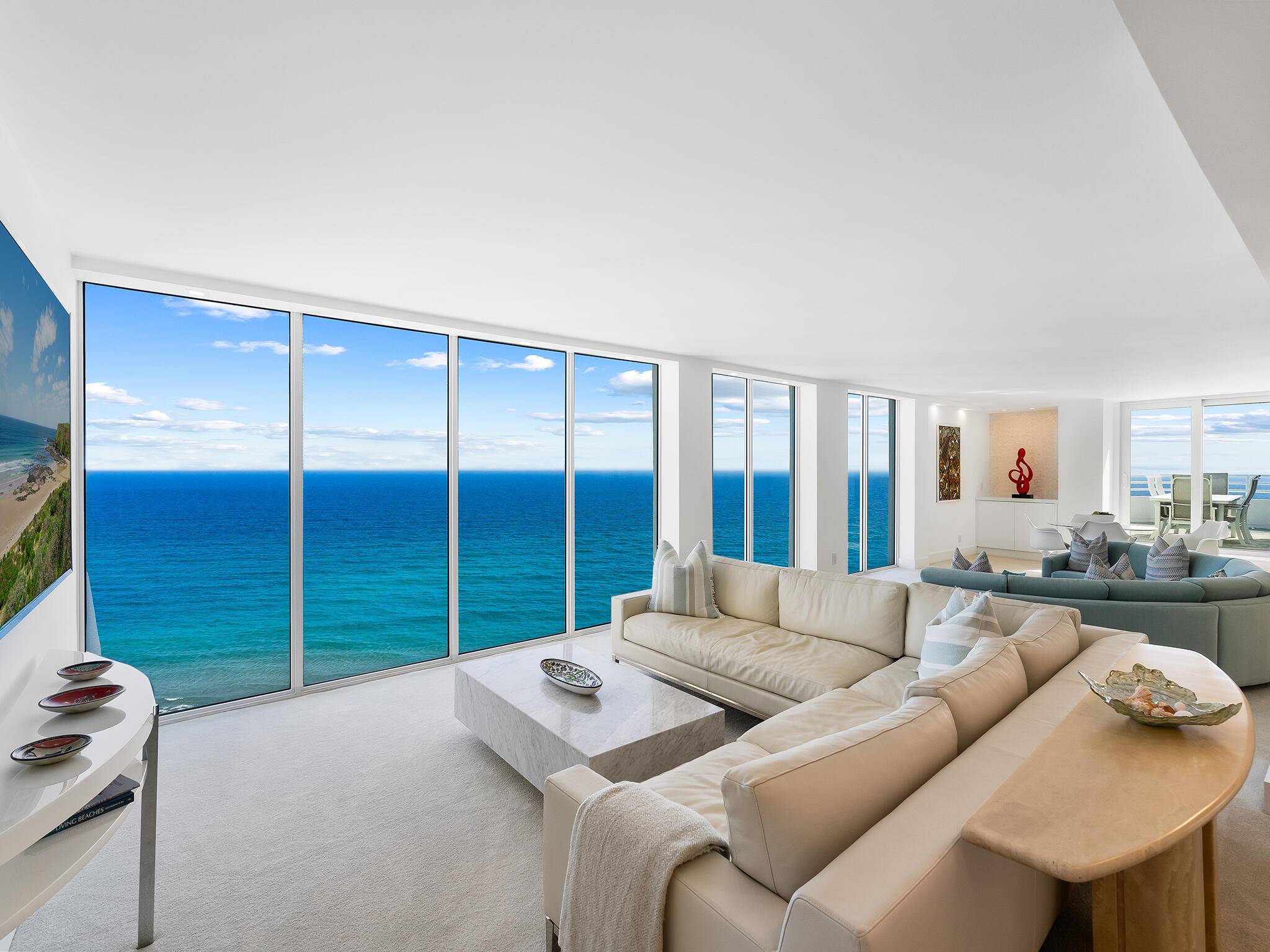 This remarkable SE corner bi level penthouse, nestled on the sand, boasts an expansive private rooftop terrace that offers unparalleled views.