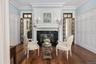 Living area featuring ornamental molding, dark wood finished floors, a high end fireplace, and a decorative wall