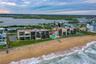 Positioned right on the sand, the oceanfront pool and beach access point are front and center, offering resort-style living with unparalleled coastal