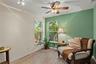 Spacious primary bedroom retreat featuring a bright and airy layout with a comfortable sitting area, creating the perfect space for relaxation and pri