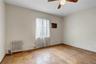 Unfurnished room with radiator, ceiling fan, and a wall mounted AC