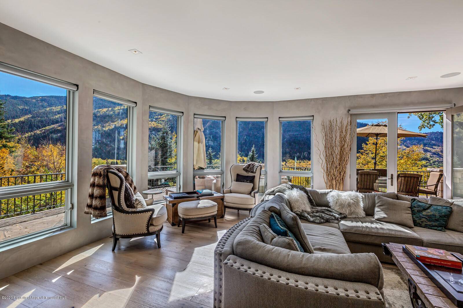 Nestled in a serene aspen grove and surrounded by mature evergreens, this luxurious private mountain estate has spectacular panoramic views spanning across the Roaring Fork Valley with awe inspiring sunsets.