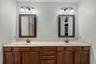 Primary bath with dual sinks and abundant vanity storage.