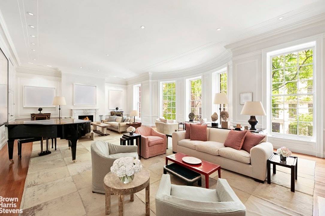Prominently situated mid block on an especially picturesque tree lined Upper East Side street, this exceptionally wide and gorgeous Neo Georgian mansion has a stately presence that conveys a sense ...