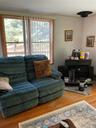 Warm wood-finish flooring with a decorative area rug