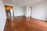 Unfurnished living room with dark wood-style flooring and baseboards