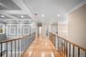 Corridor with ornamental molding, an upstairs landing, recessed lighting, light wood-style floors, and beamed ceiling