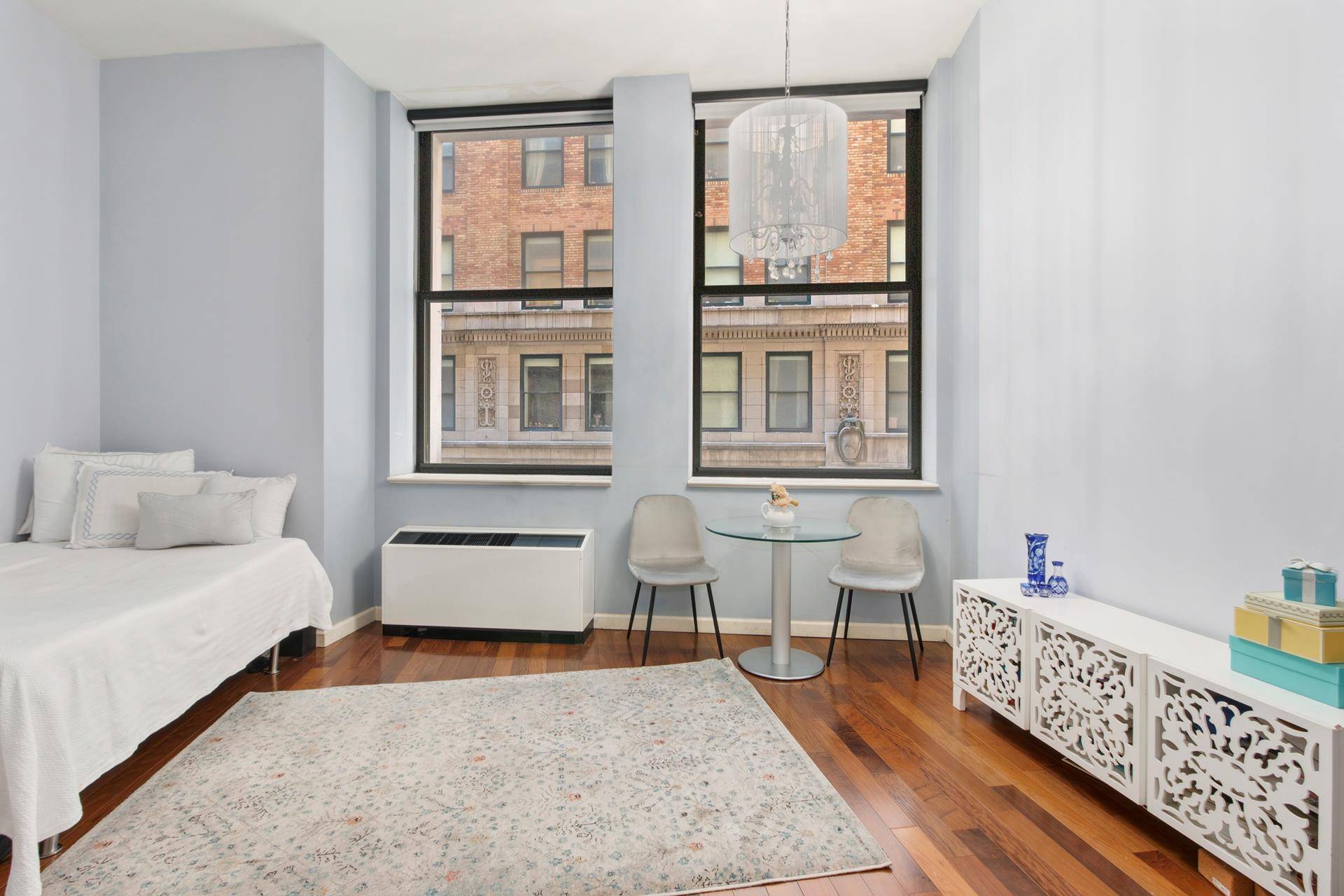 Welcome to this stunning studio apartment 307 at the Cocoa Exchange, an iconic full service condominium reminiscent of the Flatiron Building and rich in history.