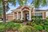 Beautiful curb appeal with mature landscaping and welcoming covered entry.