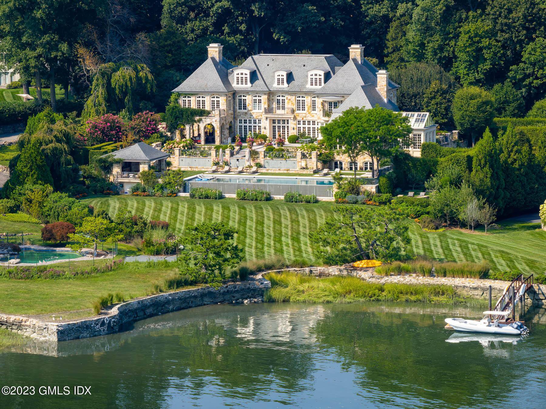 A waterfront hotel particulier in the private, gated enclave of Mead Point, this sumptuous French manor on two acres looks over rolling lawns with a 72 foot infinity pool, pool ...