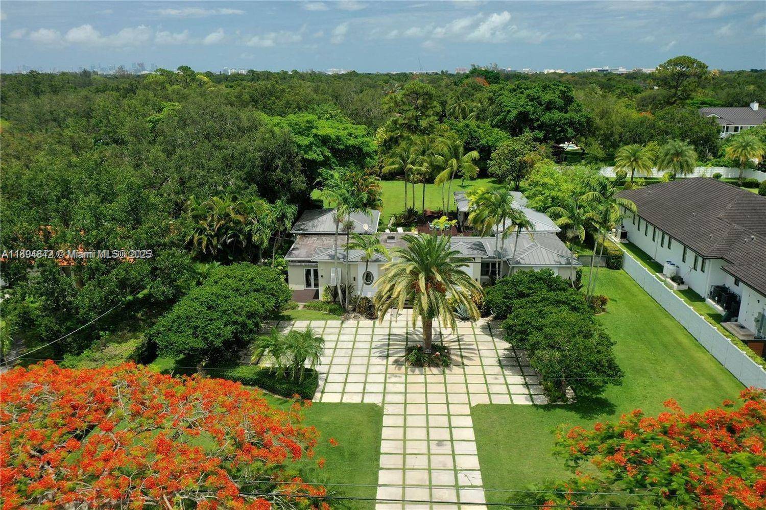 Discover your own private retreat in this tropical, resort style property set on a builder's acre with lush, mature landscaping.