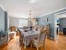 Dining area with ornamental molding, wood finished floors, and a chandelier