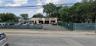 View of commercial location featuring uncovered parking