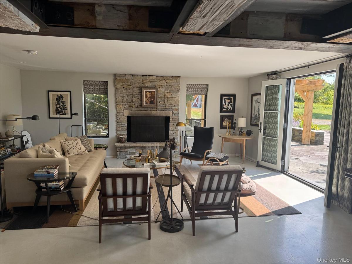 Living area featuring a fireplace and concrete floors