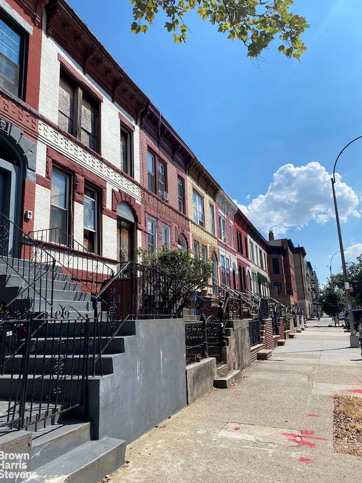 Located in the Crown Heights Historic District Phase 4, this row house with brick and rusticated stone facade is located in an intact row of historic homes.