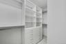 Primary Bedroom walk in closet with built in's and radiant heated floor