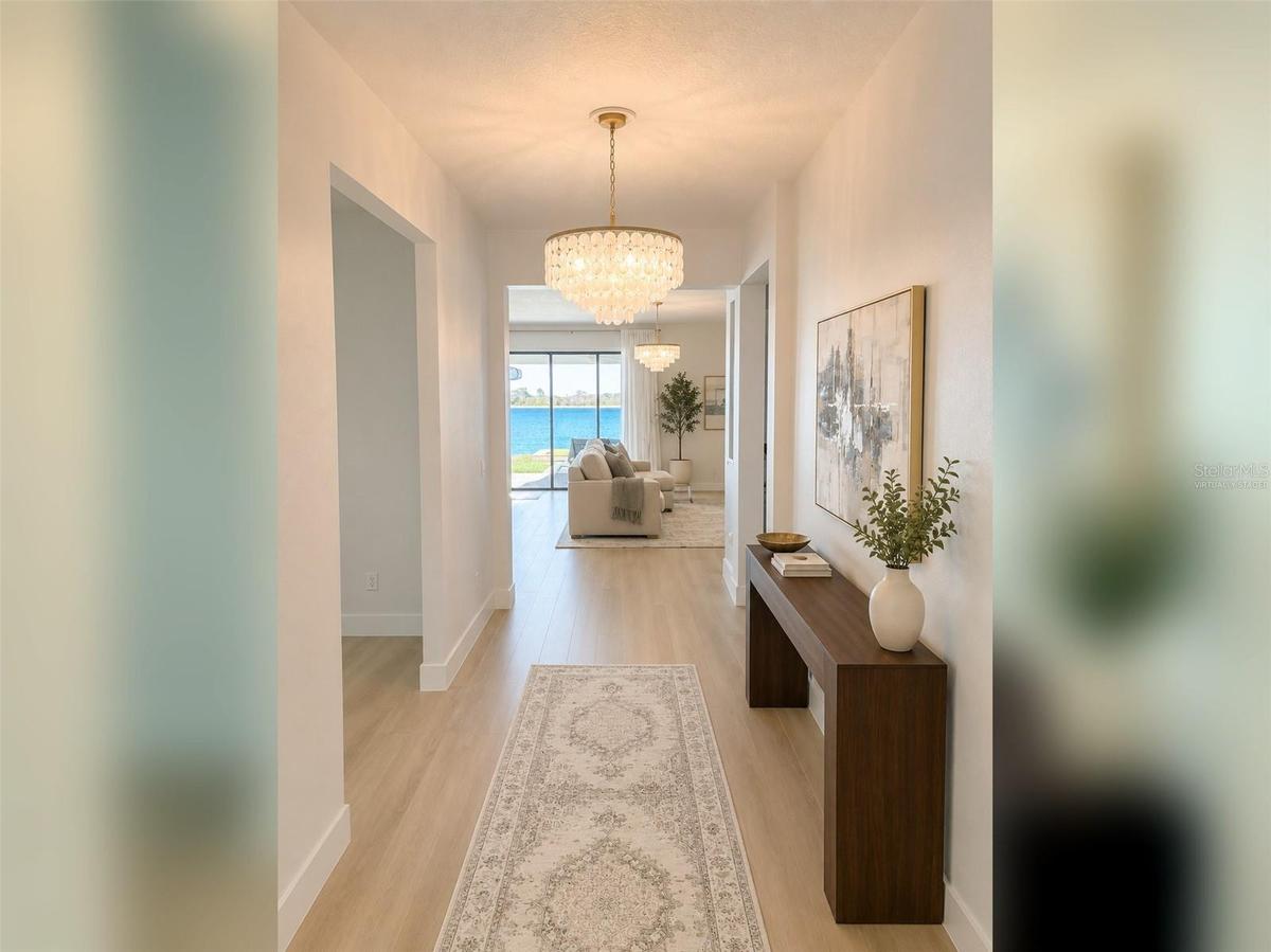 14048 Larkspur Lake Dr -Welcoming entry hallway leading into the open-concept living areas. Virtually staged.