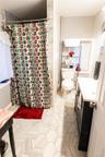 Bathroom featuring vanity, a shower with shower curtain, and light tile patterned floors