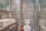 Bathroom with vanity, tile walls, and a stall shower