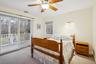 Bedroom 7 featuring carpet floors, access to outside, and ceiling fan