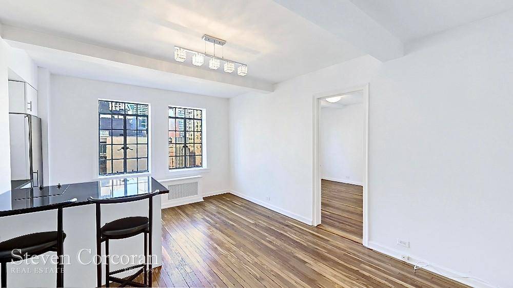 High Floor One Bedroom with commanding City Views above the Tudor City Parks and architecture.
