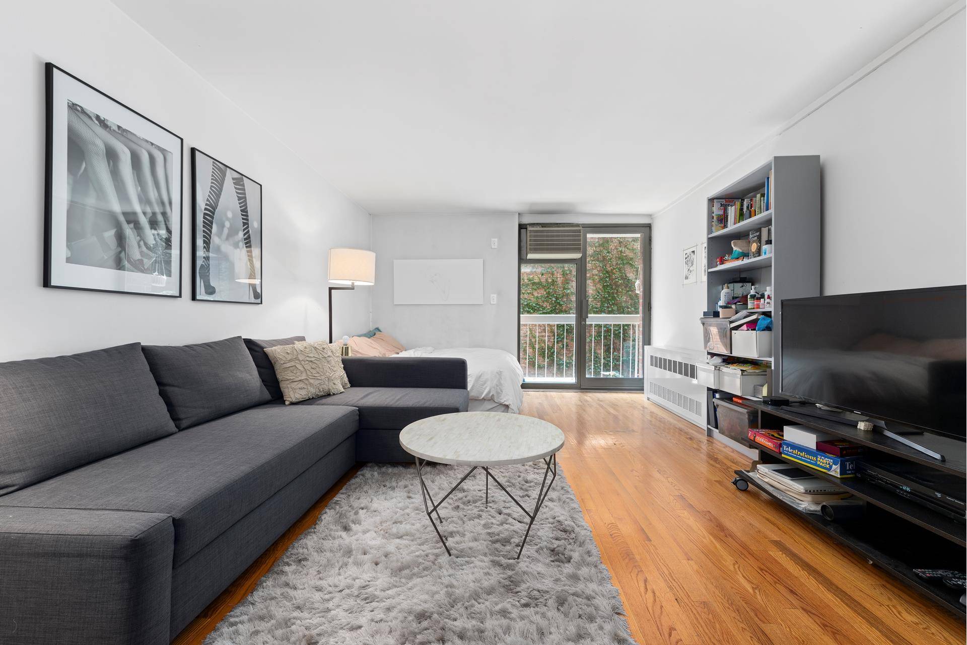 Stylishly designed studio apartment with balconyThe modern open kitchen features Caesar Stone countertops, stainless steel appliances with a dishwasher, ample cabinet space, and a separate breakfast bar that can accommodate ...