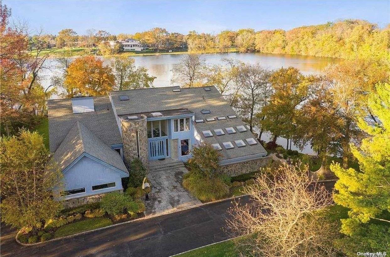 Welcome to this luxury contemporary Lakefront on a lush landscaped acre with two sides of water, and breathtaking views of Lake Success from almost every room.