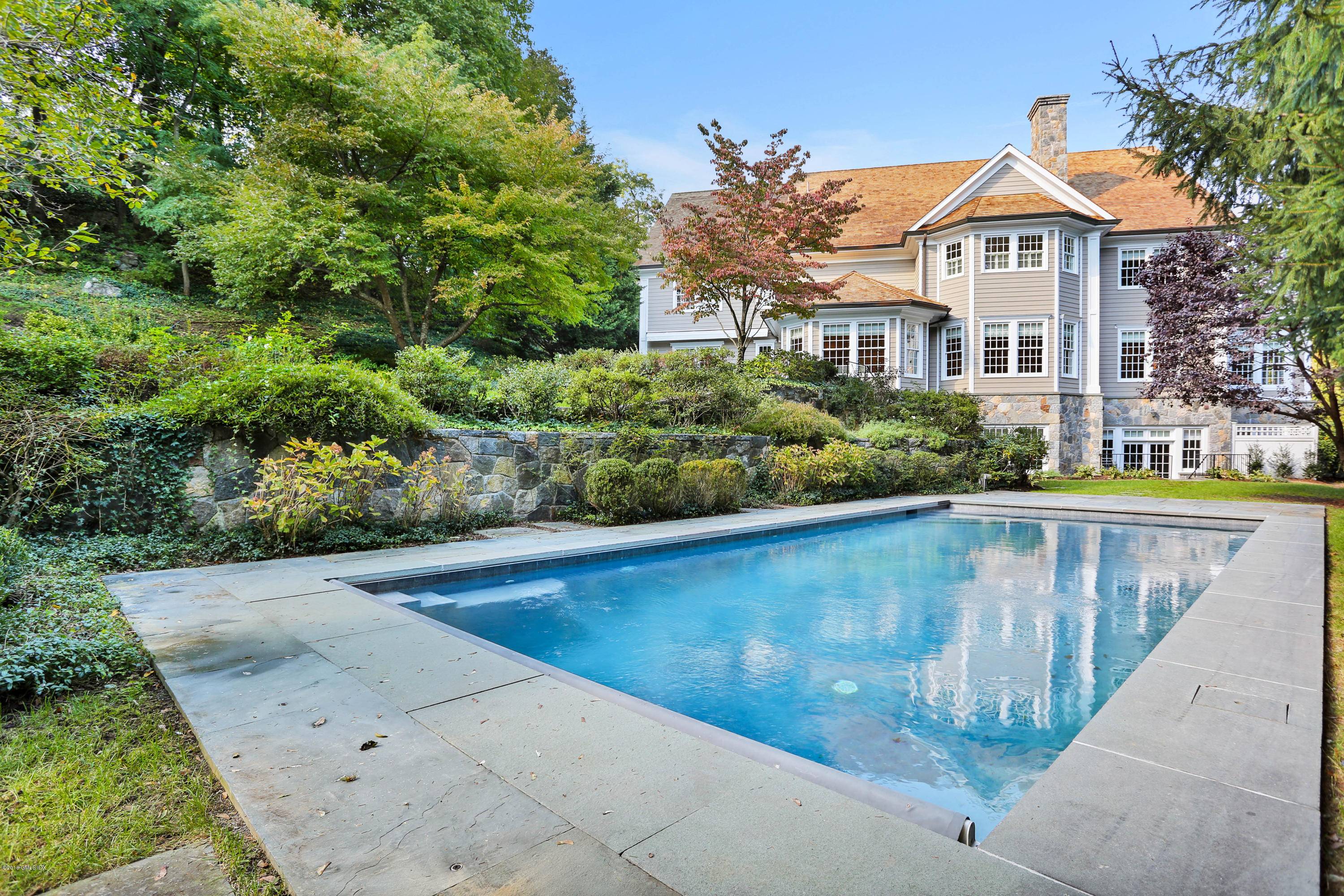Exquisitely updated six bedroom colonial provides a peaceful oasis on a 1.