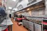 Kitchen with a paneled ceiling, light tile patterned flooring, and fridge