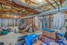 Unfinished below grade area with water heater and heating unit