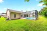 The expansive backyard is perfect for gatherings and weekend barbecues.