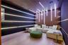 Private home theater with walnut slatted acoustic wall and ceiling panels, programmable LED linear lighting, ceiling-mounted projector, modular white