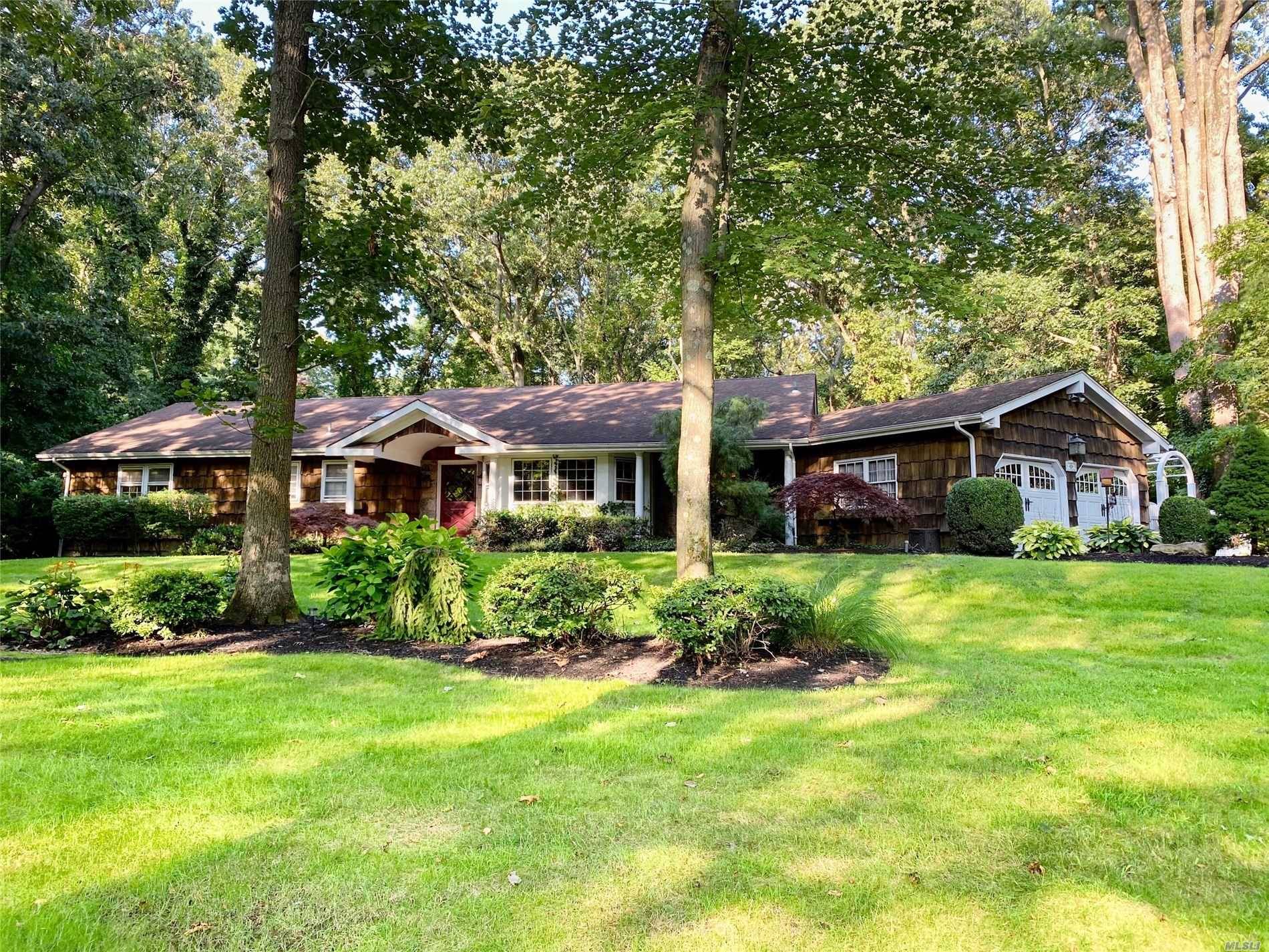 Sprawling and bright Point O' Woods ranch featuring inviting skylit family room with fireplace.